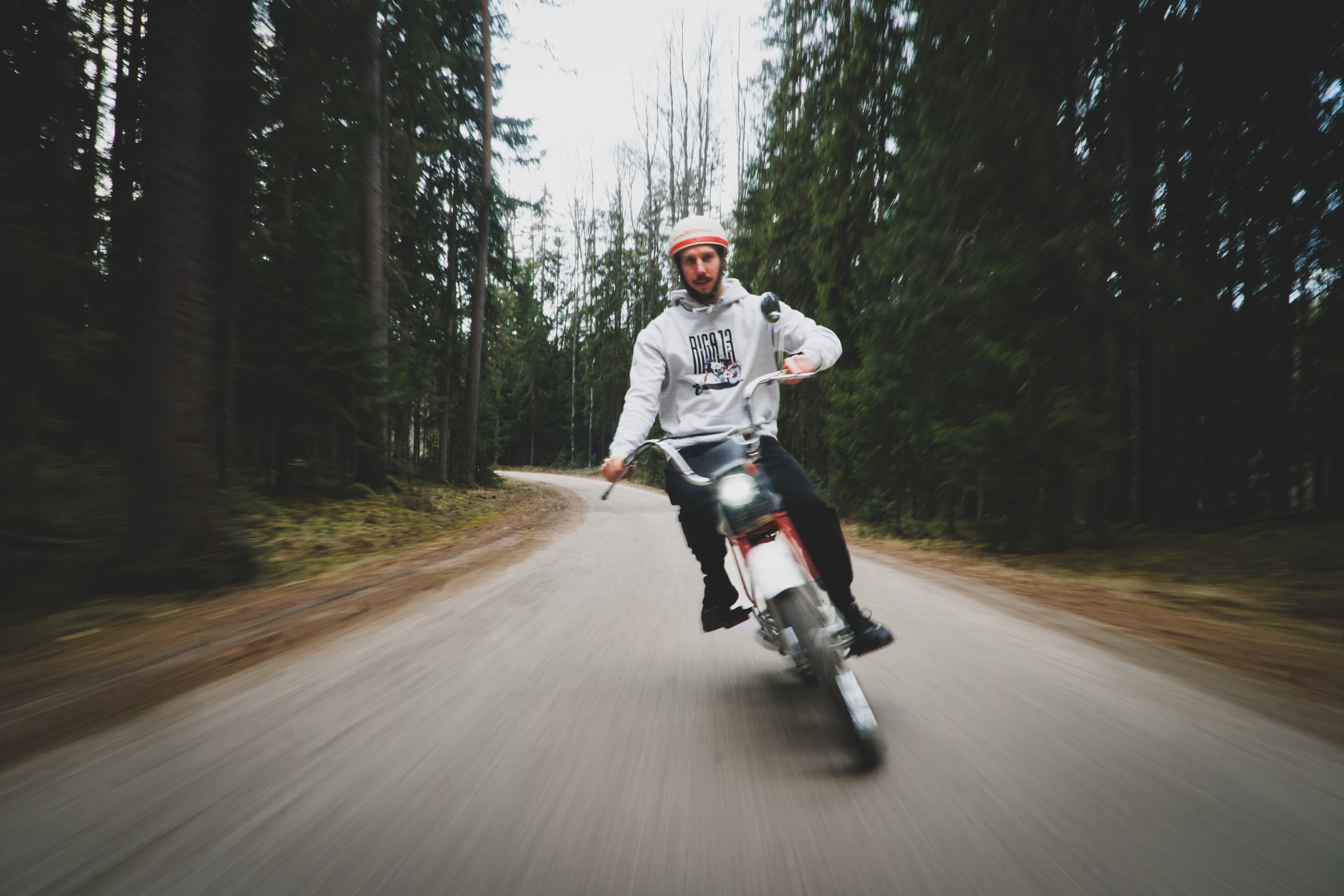 Reinis riding the Rīga 13 moped